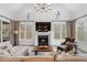Cozy living room with a fireplace, large windows, and neutral décor at 120 Nezhat Pl, Sandy Springs, GA 30350