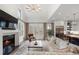 Open concept living room with fireplace, and modern kitchen, perfect for entertaining at 120 Nezhat Pl, Sandy Springs, GA 30350
