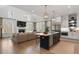 Open-concept living room and kitchen with vaulted ceiling, fireplace, and large windows at 120 Nezhat Pl, Sandy Springs, GA 30350