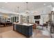 Spacious living area featuring a kitchen island, fireplace, and lots of natural light at 120 Nezhat Pl, Sandy Springs, GA 30350