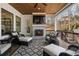 Covered porch featuring fireplace and wooded view at 120 Nezhat Pl, Sandy Springs, GA 30350