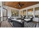 Covered porch with ceiling fan, wood flooring, and outdoor furniture at 120 Nezhat Pl, Sandy Springs, GA 30350