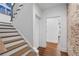 Stylish staircase with wood treads and risers, brick accent wall and adjacent hallway at 120 Nezhat Pl, Sandy Springs, GA 30350