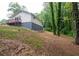Spacious backyard featuring a walkout deck and lush surrounding trees at 1563 Brannon Sw Cir, Austell, GA 30106