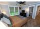 Bright bedroom with hardwood floors, ceiling fan, ensuite bathroom, and ample natural light at 1563 Brannon Sw Cir, Austell, GA 30106
