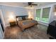 Well-lit bedroom with a ceiling fan, hardwood floors, and large windows at 1563 Brannon Sw Cir, Austell, GA 30106
