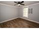Well-lit bedroom with wood-look floors, ceiling fan, and white trim at 1563 Brannon Sw Cir, Austell, GA 30106