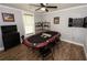 Spacious game room featuring a poker table, dartboard, and wood flooring at 1563 Brannon Sw Cir, Austell, GA 30106