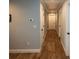 Hallway with wood flooring, white trim, and multiple doors leading to different rooms at 1563 Brannon Sw Cir, Austell, GA 30106