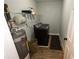 Laundry room equipped with a modern washer and dryer, shelving, and storage space at 1563 Brannon Sw Cir, Austell, GA 30106
