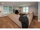 Cozy living room with large sectional sofa, wood floors, and ample natural light at 1563 Brannon Sw Cir, Austell, GA 30106