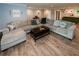 Bright living room featuring a large sectional sofa, hardwood floors, and an open layout at 1563 Brannon Sw Cir, Austell, GA 30106