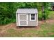 Outdoor storage shed with metal roof, window, and painted siding at 1563 Brannon Sw Cir, Austell, GA 30106