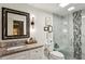 Stylish bathroom with granite countertop, updated fixtures, and glass enclosed shower at 2632 Peachtree Nw Rd # 203B, Atlanta, GA 30305