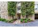 Stone facade and lush landscaping at Building B entrance, creating a welcoming approach at 2632 Peachtree Nw Rd # 203B, Atlanta, GA 30305