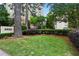 Landscaped front yard with manicured bushes and lush green grass surrounding the building at 2632 Peachtree Nw Rd # 203B, Atlanta, GA 30305