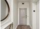 Hallway leading to unit 203 with a round mirror and marble shelf to complement the space at 2632 Peachtree Nw Rd # 203B, Atlanta, GA 30305