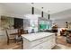Open-concept kitchen with stone countertops, modern lighting, and adjacent dining and living areas at 2632 Peachtree Nw Rd # 203B, Atlanta, GA 30305