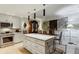 Modern kitchen features stainless steel appliances, an island with seating, and custom cabinetry at 2632 Peachtree Nw Rd # 203B, Atlanta, GA 30305
