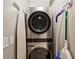 Modern laundry room with a stacked washer and dryer unit and convenient storage solutions at 2632 Peachtree Nw Rd # 203B, Atlanta, GA 30305
