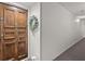 Hallway with a solid wood door, decorative wreath, and neutral wall color at 305 Ridley Howard Ct, Decatur, GA 30030