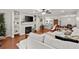 Open-concept living room featuring hardwood floors, a fireplace, built-in shelves, and neutral decor at 305 Ridley Howard Ct, Decatur, GA 30030