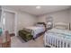 Comfortable bedroom featuring two twin beds with patterned bedding, and an olive green ottoman at 4100 Springlake Cir, Buford, GA 30519