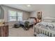 Comfortable bedroom with two twin beds, a wooden dresser, and soft natural light from the window at 4100 Springlake Cir, Buford, GA 30519