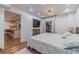Bright bedroom with wood floors, a TV, and a glimpse of the kitchen through an open doorway at 4100 Springlake Cir, Buford, GA 30519
