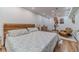 Serene bedroom featuring a wooden headboard, decorative wall art, and cozy sitting area at 4100 Springlake Cir, Buford, GA 30519