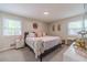 Charming bedroom with a queen bed adorned with pink accents, complemented by stylish bedside tables and decor at 4100 Springlake Cir, Buford, GA 30519