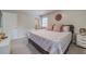 Cozy bedroom featuring a queen bed with pink pillows, a white nightstand, and soft natural light at 4100 Springlake Cir, Buford, GA 30519