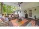 Inviting covered deck with cozy seating, ceiling fans, and colorful outdoor rug, ideal for relaxing and enjoying the outdoors at 4100 Springlake Cir, Buford, GA 30519