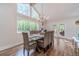 Bright dining room with expansive windows, a modern chandelier, and seating for eight at 4100 Springlake Cir, Buford, GA 30519
