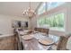 Inviting dining room with a large window overlooking the backyard, complemented by a chandelier and stylish table setting at 4100 Springlake Cir, Buford, GA 30519