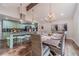 Elegant dining area with modern lighting, seating for eight, and hardwood floors at 4100 Springlake Cir, Buford, GA 30519