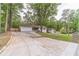 Charming single-story home featuring a lush front yard, attached two-car garage, and extra long driveway at 4100 Springlake Cir, Buford, GA 30519