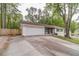 Charming single-story home featuring a lush front yard, attached two-car garage, and extra long driveway at 4100 Springlake Cir, Buford, GA 30519