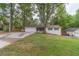 Charming single-story home featuring a lush front yard, attached two-car garage, and inviting front porch at 4100 Springlake Cir, Buford, GA 30519