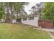 Charming single-story home featuring a lush front yard, attached two-car garage, and covered side porch at 4100 Springlake Cir, Buford, GA 30519