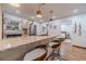 Bright kitchen featuring granite countertops, stainless steel appliances, and three bar stools for dining at 4100 Springlake Cir, Buford, GA 30519