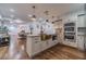 Charming kitchen boasts stainless steel appliances, granite countertops, and a stylish bronze farmhouse sink at 4100 Springlake Cir, Buford, GA 30519