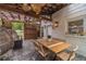 Inviting covered patio with a wooden pergola, stylish rattan chairs, and a spacious table, ideal for outdoor gatherings at 4100 Springlake Cir, Buford, GA 30519