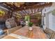 Charming covered patio featuring wood pergola, comfortable seating, and a large dining table perfect for entertaining at 4100 Springlake Cir, Buford, GA 30519