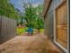Outdoor patio area with a stone base, surrounded by a wooden fence, with seating and a grill at 6892 Autumn Hills Dr, Douglasville, GA 30135