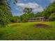 Green backyard with a view of the home, trees and patio at 6892 Autumn Hills Dr, Douglasville, GA 30135