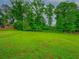 Large fenced-in backyard with lush green grass, perfect for outdoor activities at 6892 Autumn Hills Dr, Douglasville, GA 30135