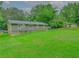 Expansive backyard view showcasing the home's exterior, green lawn and mature trees at 6892 Autumn Hills Dr, Douglasville, GA 30135