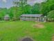 View of the home's spacious backyard featuring lush lawn and a patio area with outdoor seating at 6892 Autumn Hills Dr, Douglasville, GA 30135