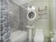 Stylish bathroom featuring a tub/shower with modern tiling, a pedestal sink, and decorative shelves at 6892 Autumn Hills Dr, Douglasville, GA 30135